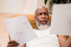 Creating Compelling Content That Convert (Post Sample) 5 "business owner calculating advertising budget with concerned expression"